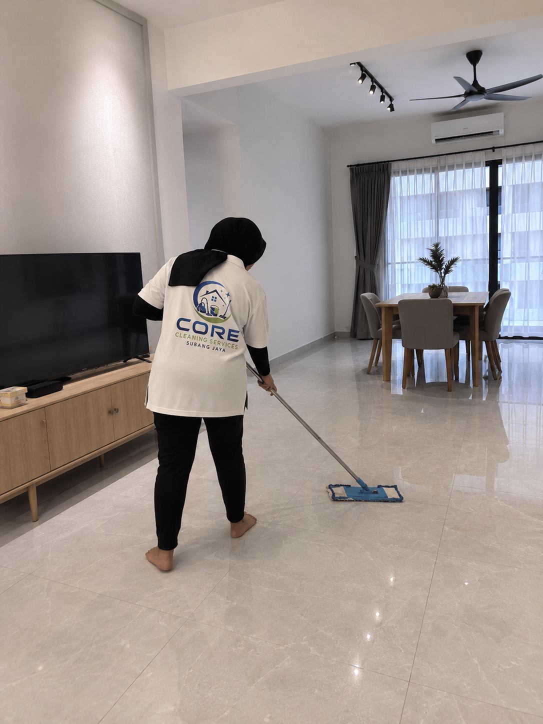 Part-time maid mopping floors in a Subang Jaya home