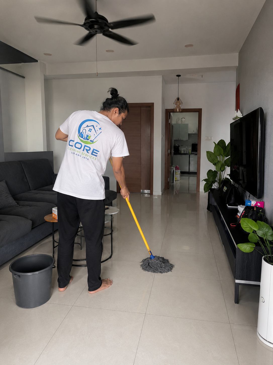 Core Cleaning Services Subang Jaya part-time maid tidying a living room in Subang Jaya